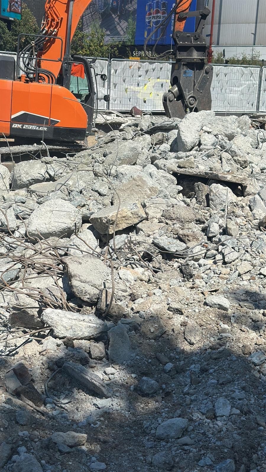 Foarfecă hidraulică tăind beton armat la demolarea Pasajul Unirii